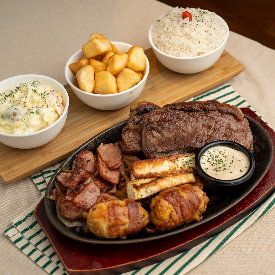 Brazilian Barbecue sharing plate with picanha, sausage, halloumi and chicken with bacon